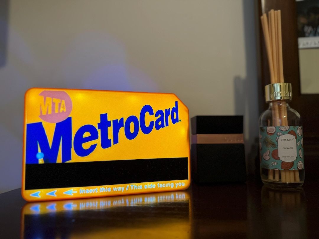 MetroCard light box lit up next to a diffuser on a desk