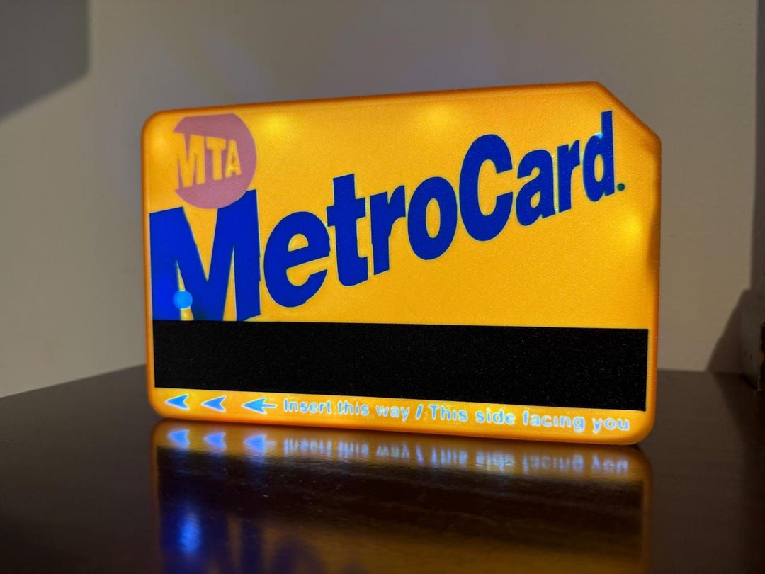 The MetroCard light box glowing on a dark shelf